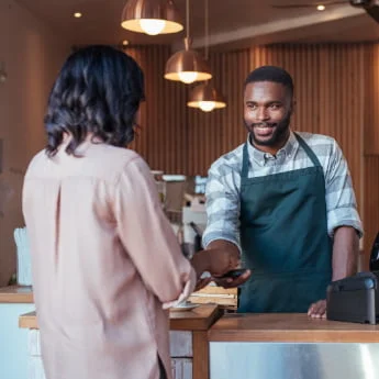 Tap-to-pay-use-case-for-cafes-cafeterias-man-barista-taking-contactless-payment