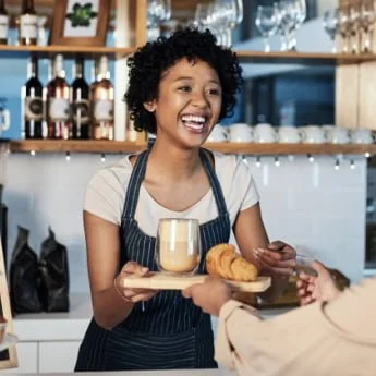 Tap-to-pay-use-case-for-cafes-cafeterias-hospitality-lady-barista-sells-food-and-beverage-to-customer